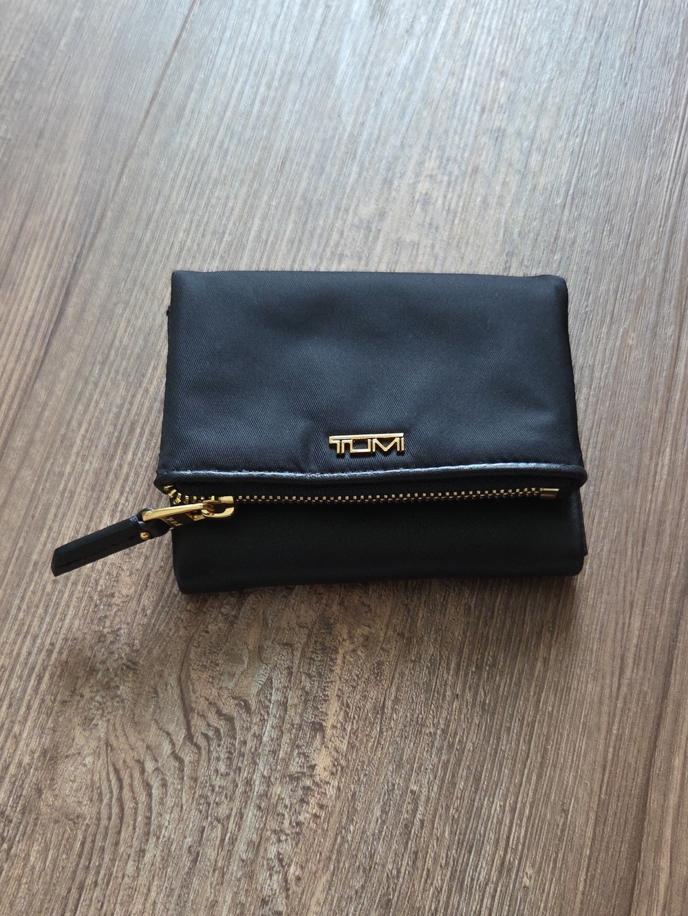 Tumi Voyageur Black Fold-Over Wallet with Gold Accents